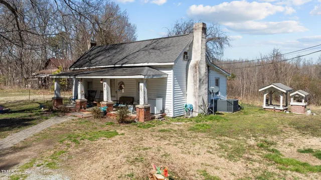 a view of a house with backyard porch and furniture