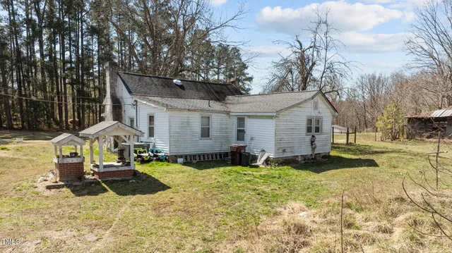 a view of a house with a yard covered with snow in the background