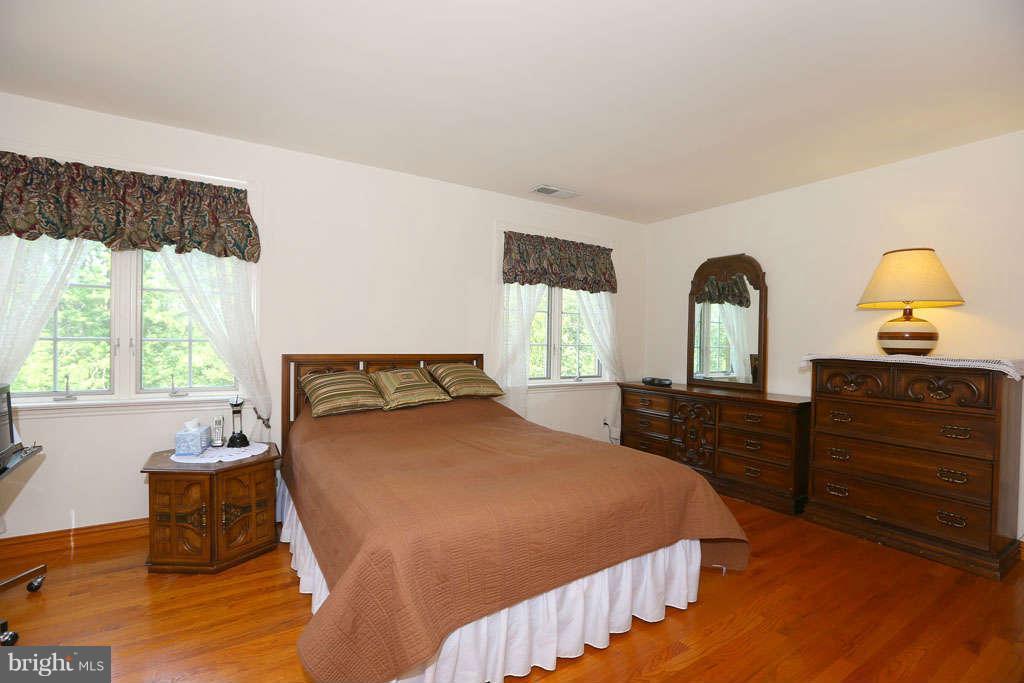 12530 Falls Road Potomac, MD 20854 - Photo 19 of 27 a bedroom with a bed and a dresser