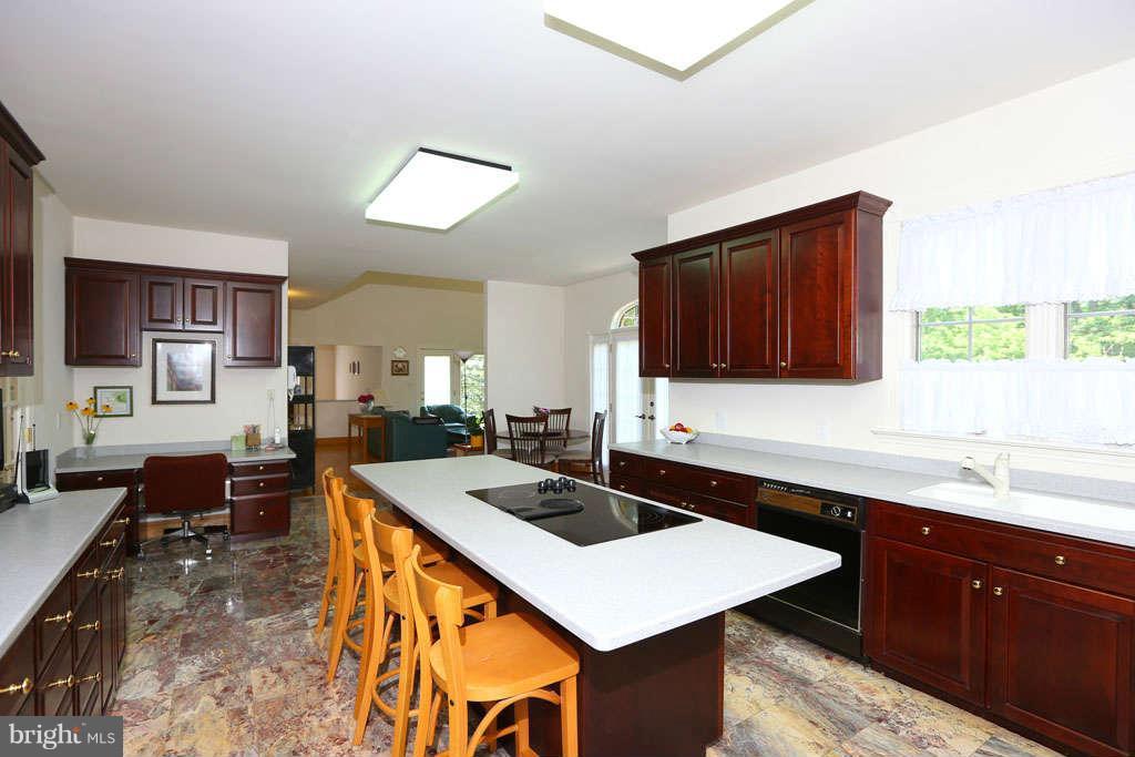 12530 Falls Road Potomac, MD 20854 - Photo 8 of 27 a kitchen with a stove a sink and a refrigerator