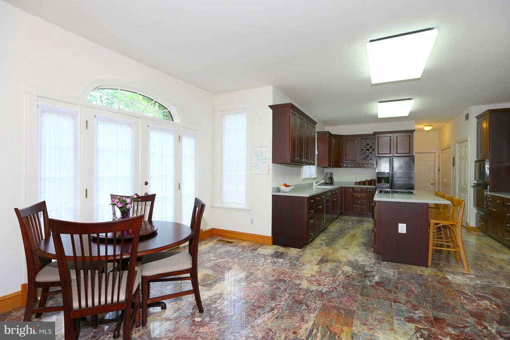 12530 Falls Road Potomac, MD 20854 - Photo 10 of 27 a view of a dining room with furniture and a kitchen
