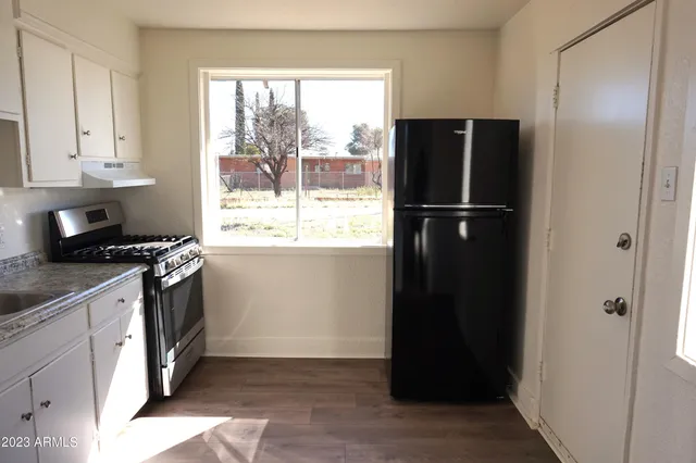a kitchen with a refrigerator and a sink