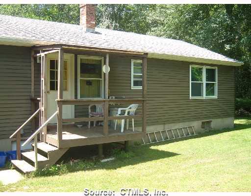 a view of house with backyard outdoor seating area and green space