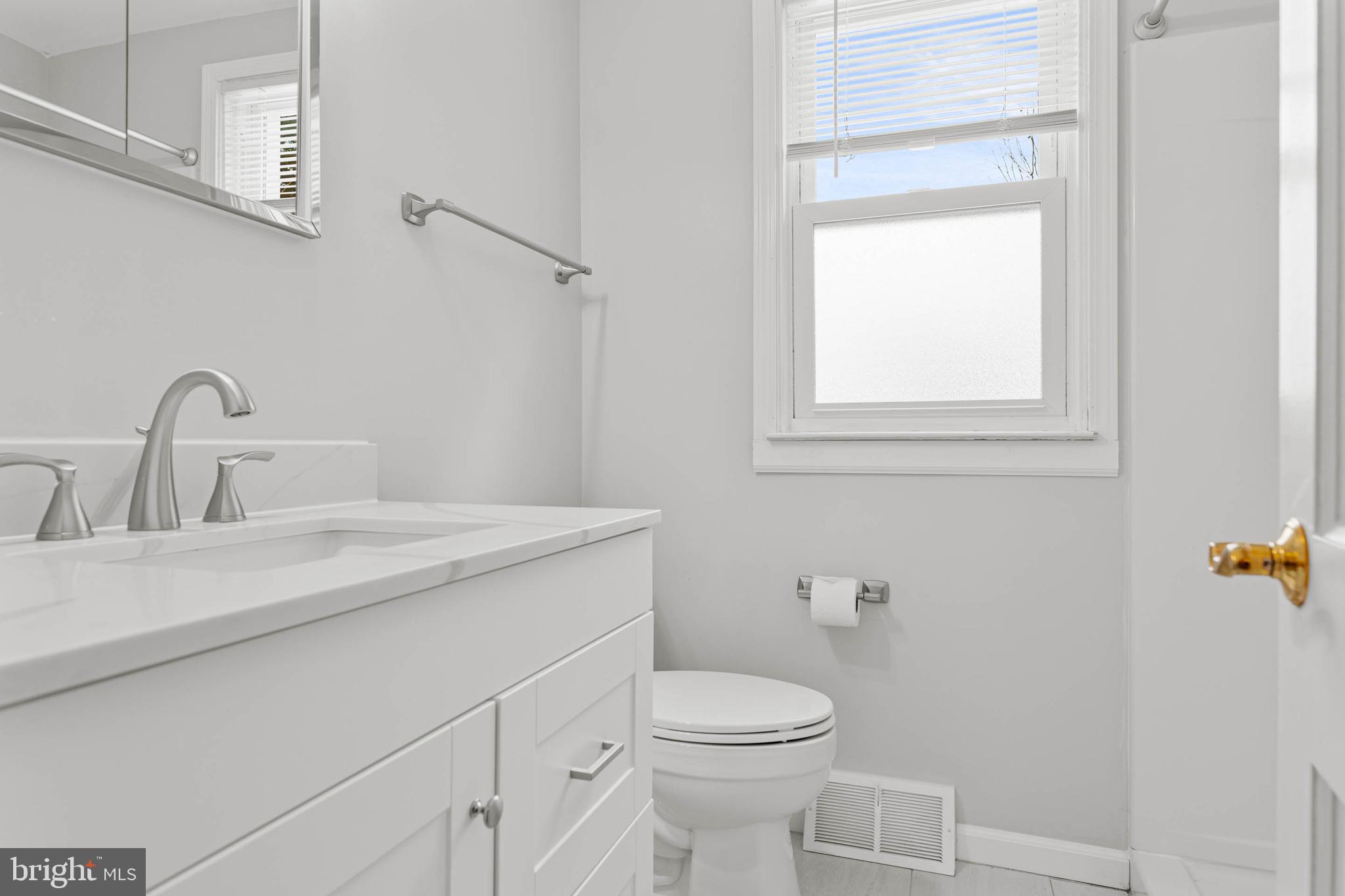 22 Longwood Drive Wayne, PA 19087 - Photo 15 of 28 a bathroom with a sink a toilet and with mirror
