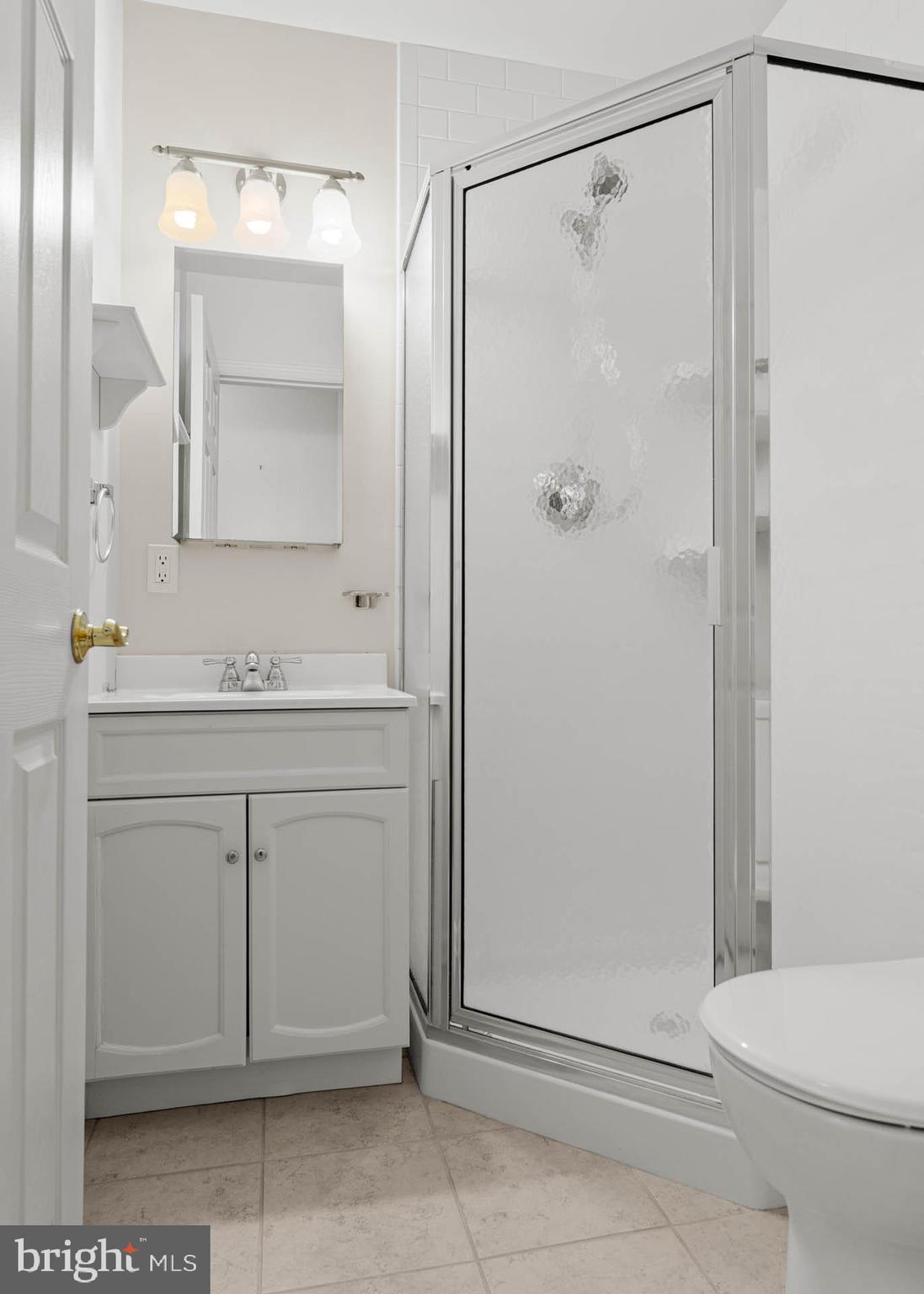 22 Longwood Drive Wayne, PA 19087 - Photo 19 of 28 a bathroom with a sink a toilet and shower