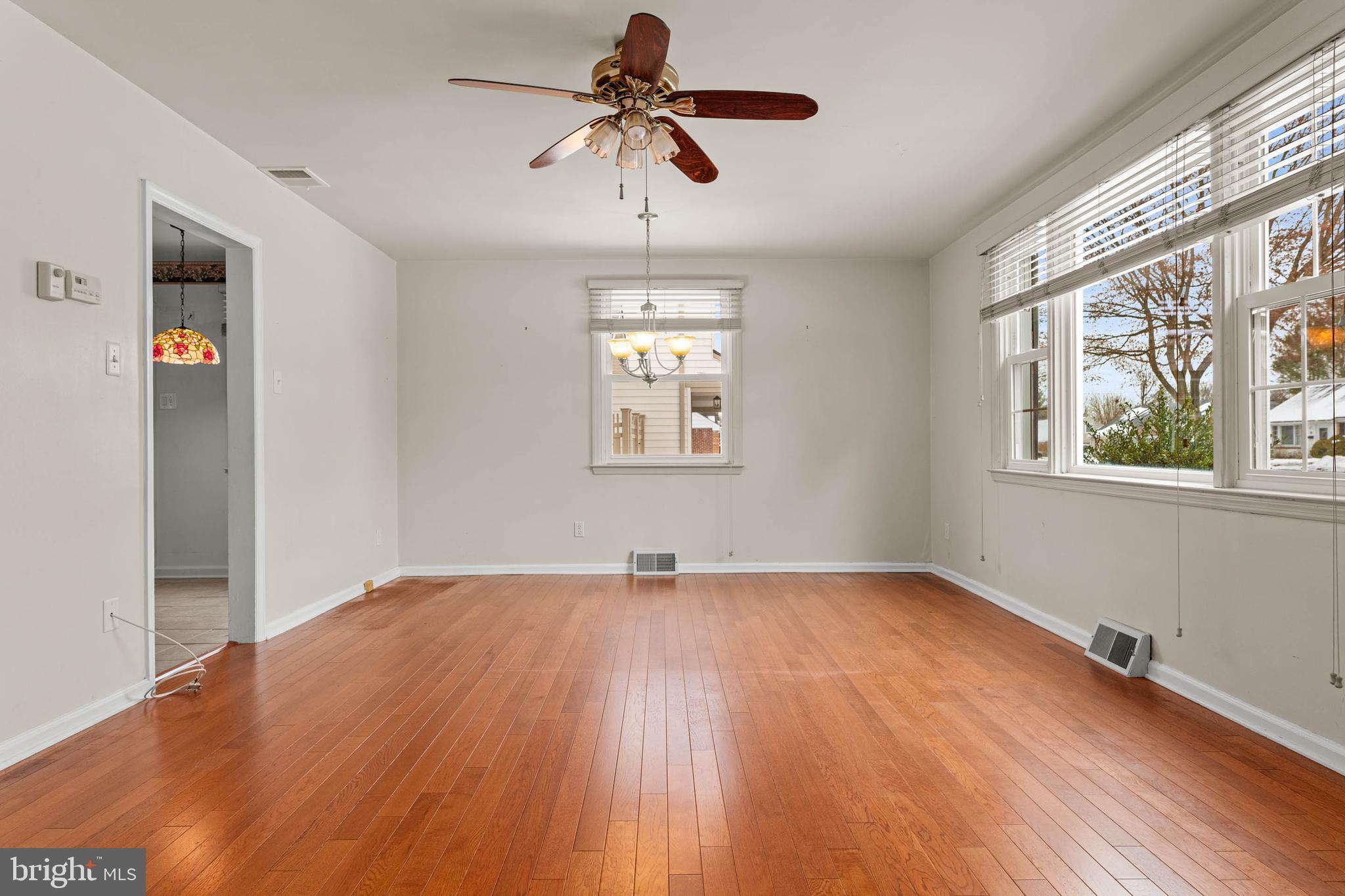 22 Longwood Drive Wayne, PA 19087 - Photo 4 of 28 a view of empty room with wooden floor and fan