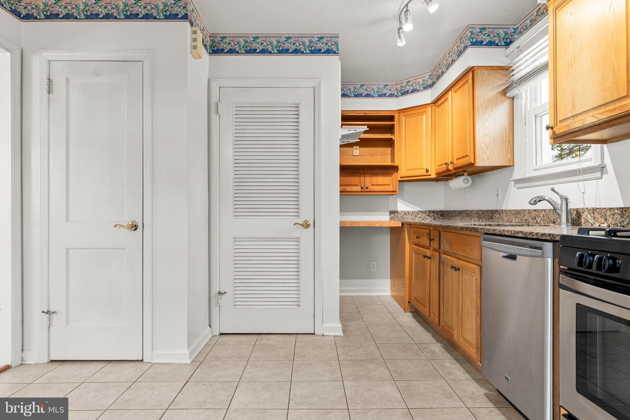 22 Longwood Drive Wayne, PA 19087 - Photo 7 of 28 a kitchen with stainless steel appliances granite countertop a sink and a stove