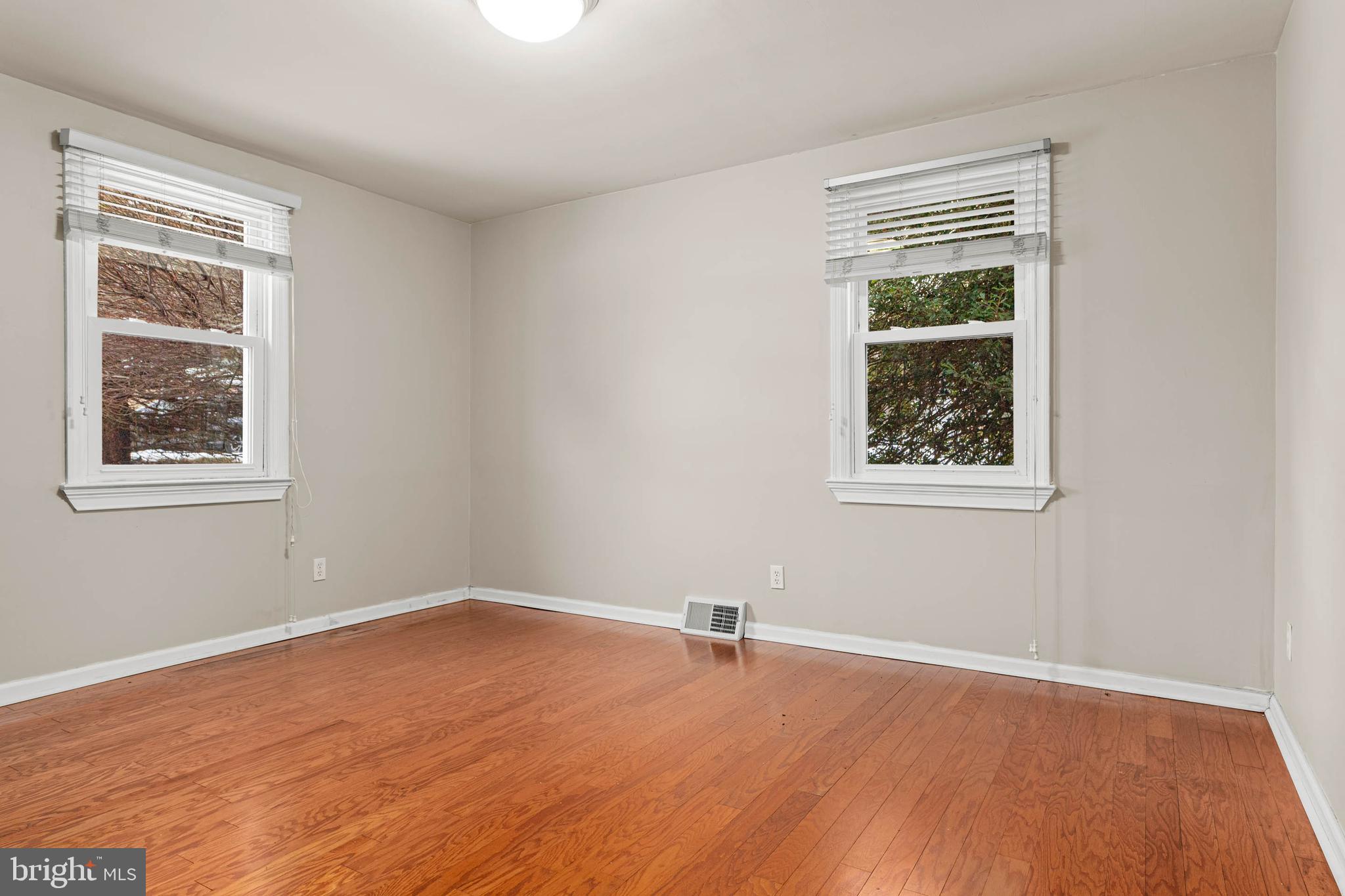 22 Longwood Drive Wayne, PA 19087 - Photo 10 of 28 a view of an empty room with wooden floor and a window