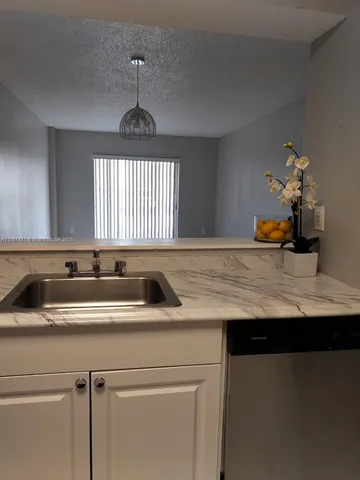 a view of a room with an empty space and a sink