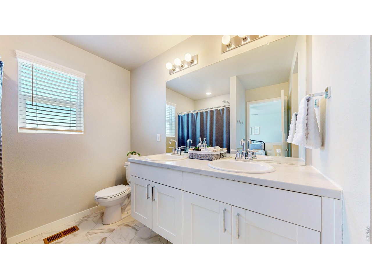 260 Pawnee Road, Unit D3 Ault, CO 80610 - Photo 22 of 44 Primary ensuite bathroom with double sinks and tile floor.