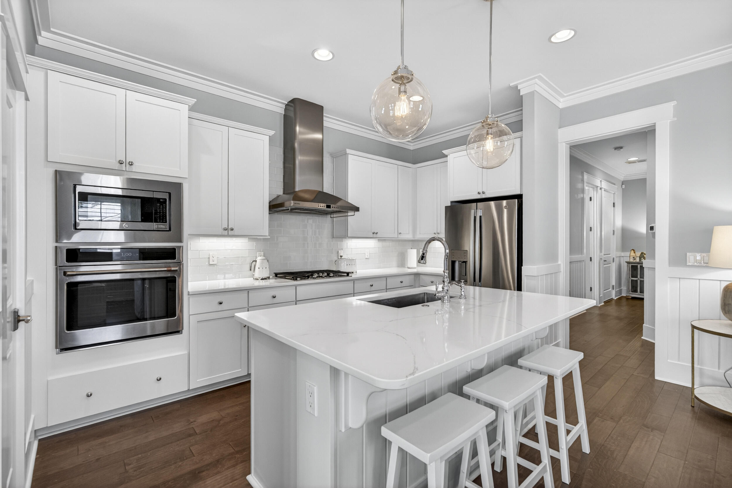 117 Prairie Pass Santa Rosa Beach, FL 32459 - Photo 12 of 56 a large kitchen with kitchen island white cabinets and stainless steel appliances