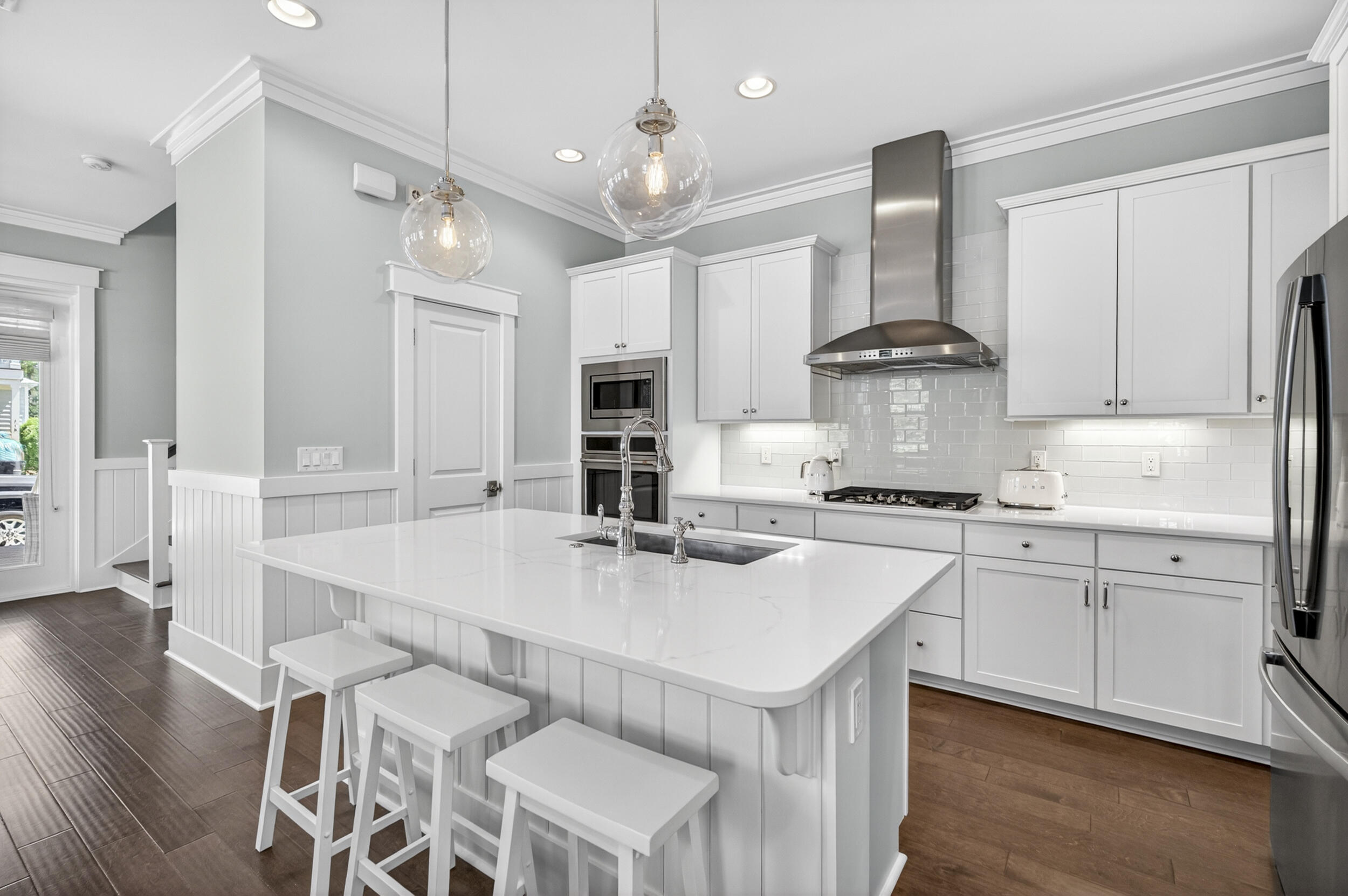117 Prairie Pass Santa Rosa Beach, FL 32459 - Photo 14 of 56 a kitchen with stainless steel appliances a sink a stove a refrigerator and white cabinets with wooden floor