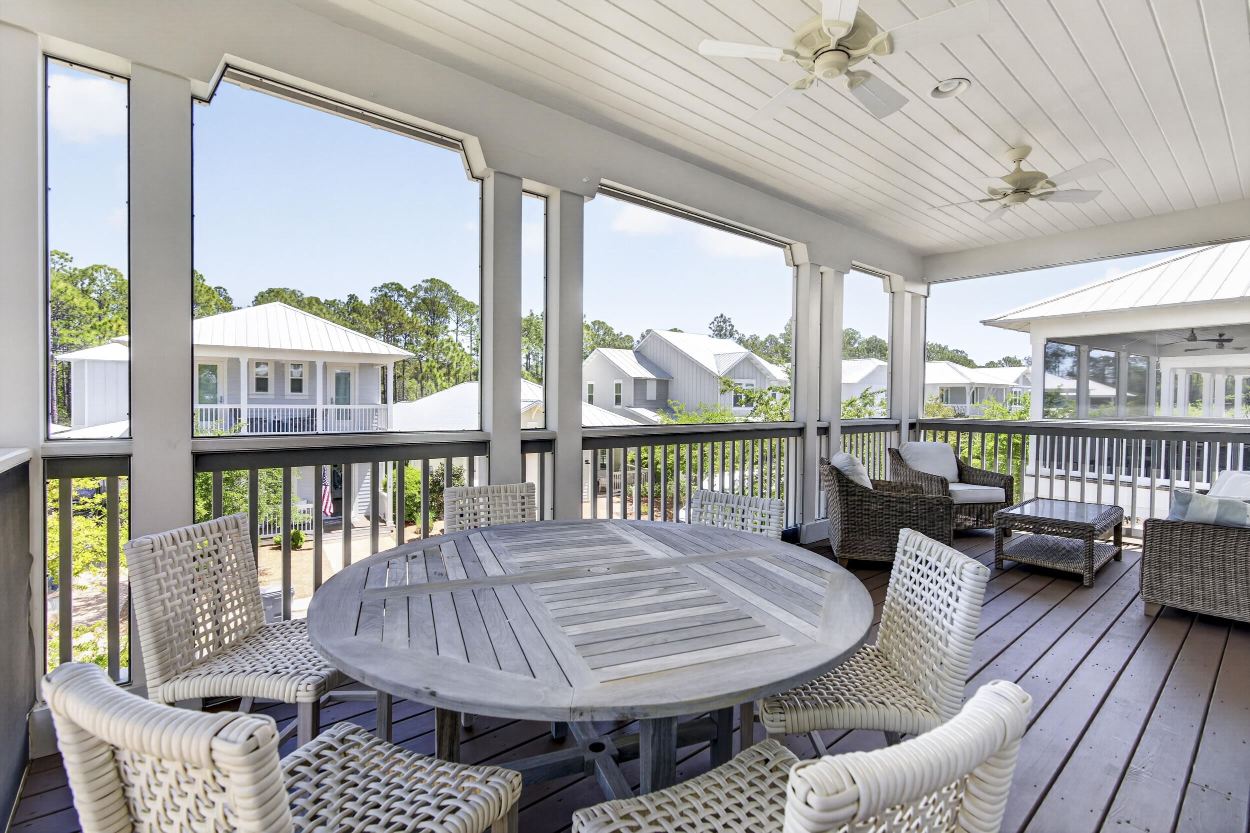 117 Prairie Pass Santa Rosa Beach, FL 32459 - Photo 29 of 56 a balcony filled with furniture and wooden floor