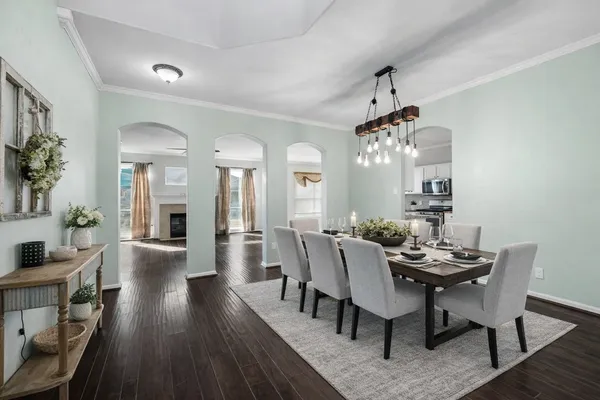 a view of a dining room with furniture and wooden floor