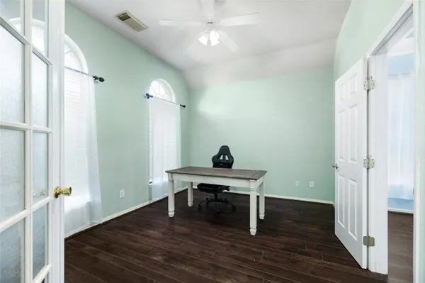 a bedroom with furniture and a wooden floor