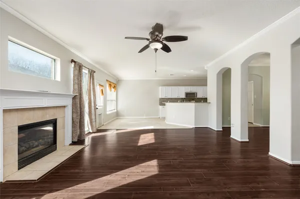 a view of an empty room with exposed radiator and fireplace