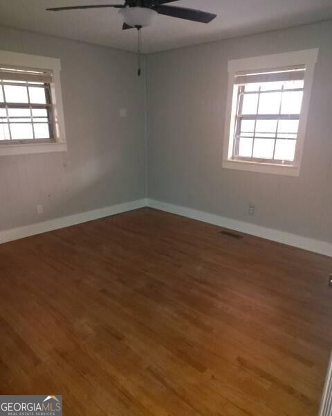 46 Mohawk Trail Ringgold, GA 30736 - Photo 4 of 16 an empty room with wooden floor and windows