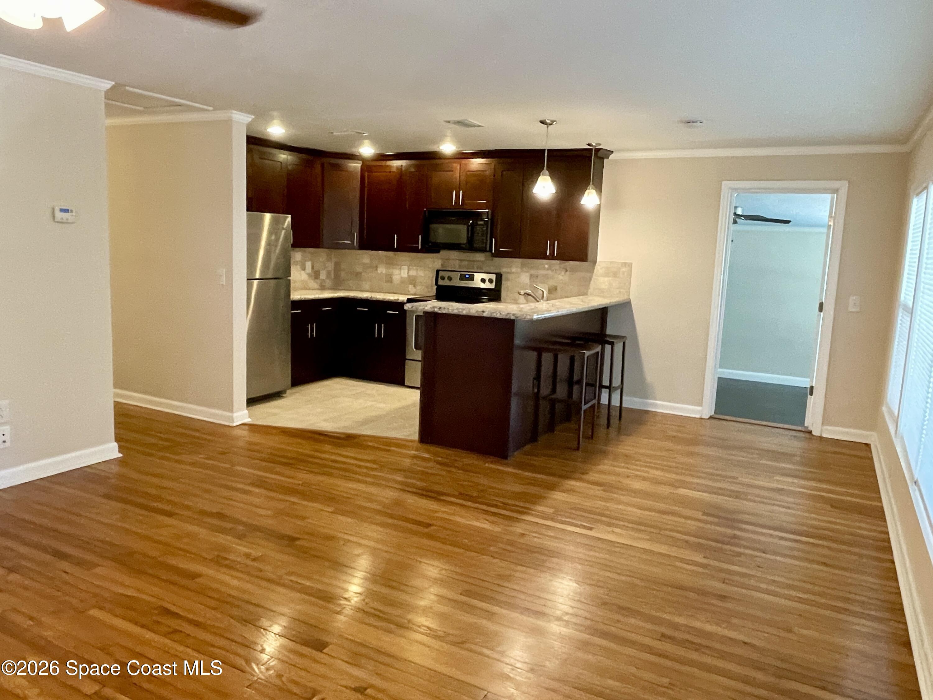 7260 Blue Shore Road Grant, FL 32949 - Photo 6 of 23 Living room towards kitchen & Master
