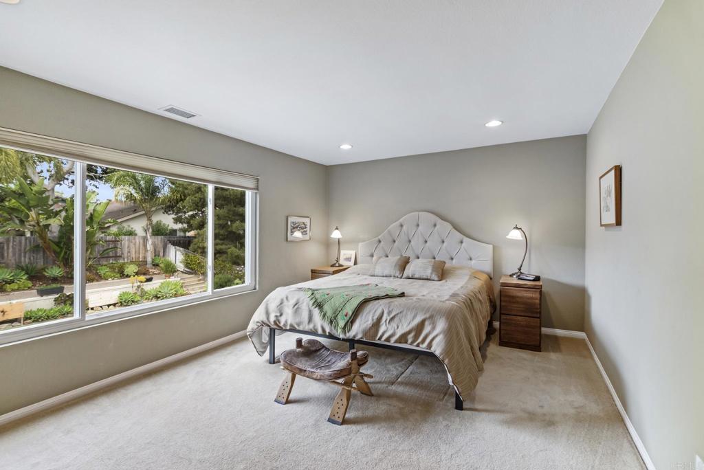 1462 Pegaso Street Encinitas, CA 92024 - Photo 14 of 36 a bedroom with a bed and a large window