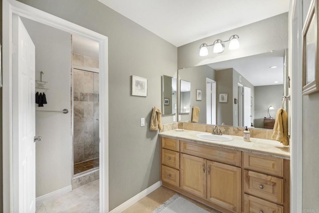 1462 Pegaso Street Encinitas, CA 92024 - Photo 17 of 36 a bathroom with a granite countertop sink mirror and double