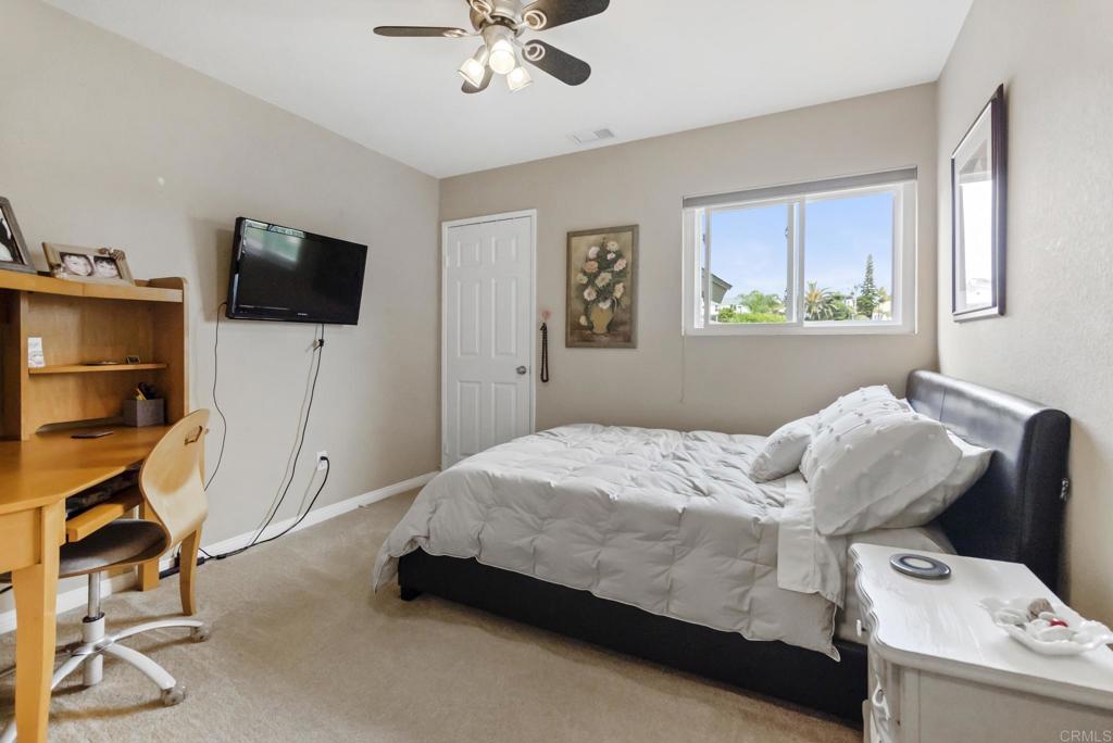 1462 Pegaso Street Encinitas, CA 92024 - Photo 21 of 36 a bedroom with a bed and furniture