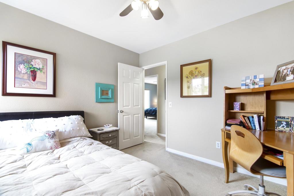 1462 Pegaso Street Encinitas, CA 92024 - Photo 22 of 36 a bedroom with a bed and wooden floor