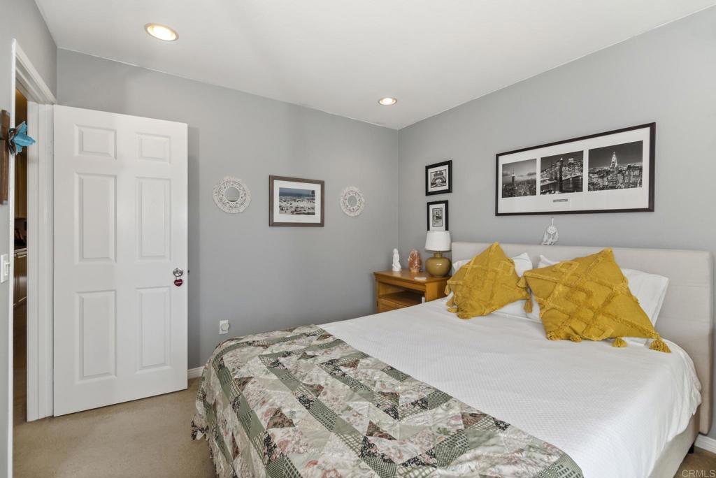 1462 Pegaso Street Encinitas, CA 92024 - Photo 25 of 36 a bedroom with a bed and a painting on the wall