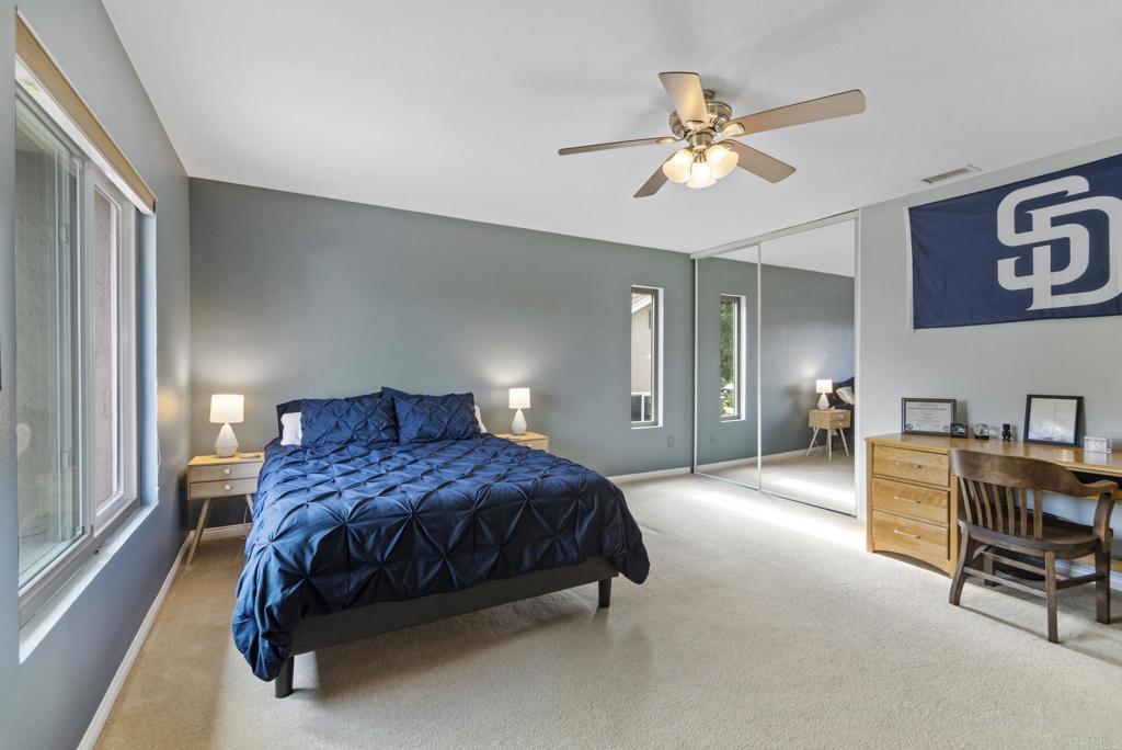 1462 Pegaso Street Encinitas, CA 92024 - Photo 28 of 36 a spacious bedroom with a bed and a chandelier