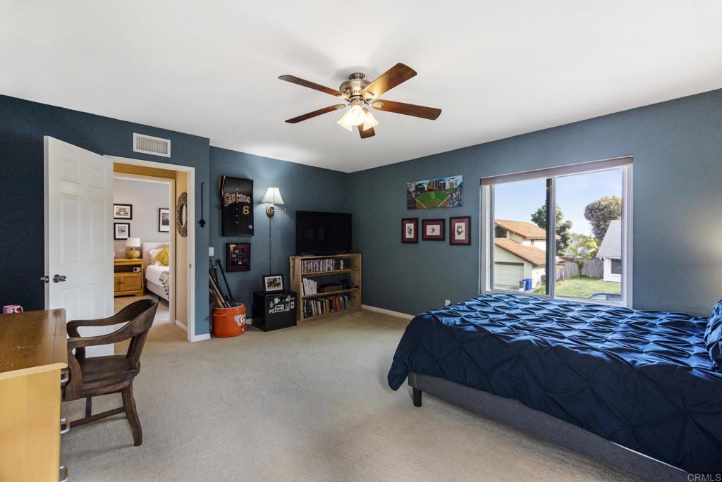 1462 Pegaso Street Encinitas, CA 92024 - Photo 29 of 36 a bedroom with a bed furniture and a flat screen tv