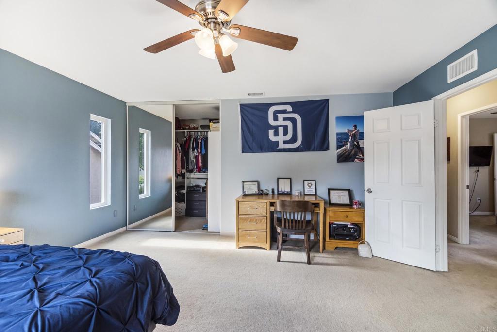 1462 Pegaso Street Encinitas, CA 92024 - Photo 30 of 36 a bed room with a bed and a ceiling fan