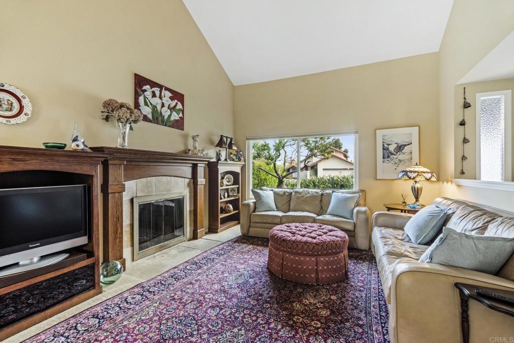 1462 Pegaso Street Encinitas, CA 92024 - Photo 31 of 36 a living room with furniture a flat screen tv and a fireplace