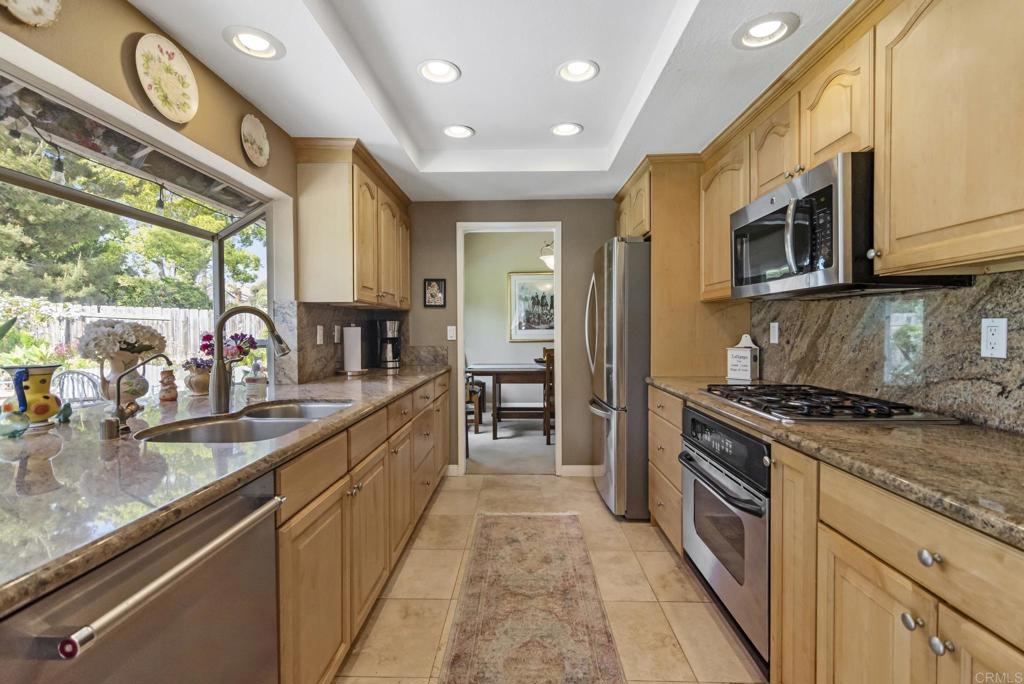 1462 Pegaso Street Encinitas, CA 92024 - Photo 34 of 36 a kitchen with stainless steel appliances granite countertop a stove and a sink