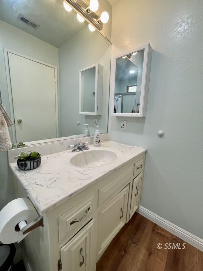 401 South Lincoln Street Ridgecrest, CA 93555 - Photo 20 of 27 a bathroom with a sink vanity and mirror