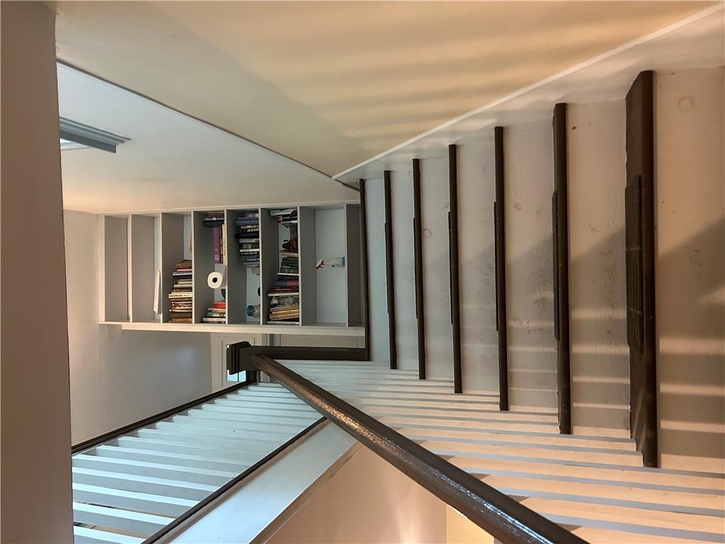 7 Allegheny Road Mount Bethel, PA 18343 - Photo 50 of 71 Custom built-in shelving lines the wall above a striking open-riser staircase.