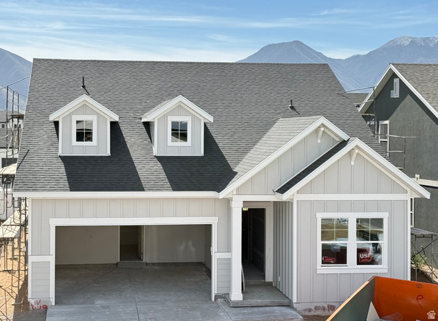 2227 Fortune Lane, Unit 448 Mapleton, UT 84664 - Photo 1 of 4 View of front of house featuring a mountain view, roof with shingles, board and batten siding, a garage, and driveway