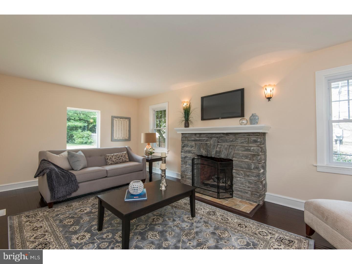 408 Lenox Road Havertown, PA 19083 - Photo 2 of 25 a living room with furniture a flat screen tv and a fireplace