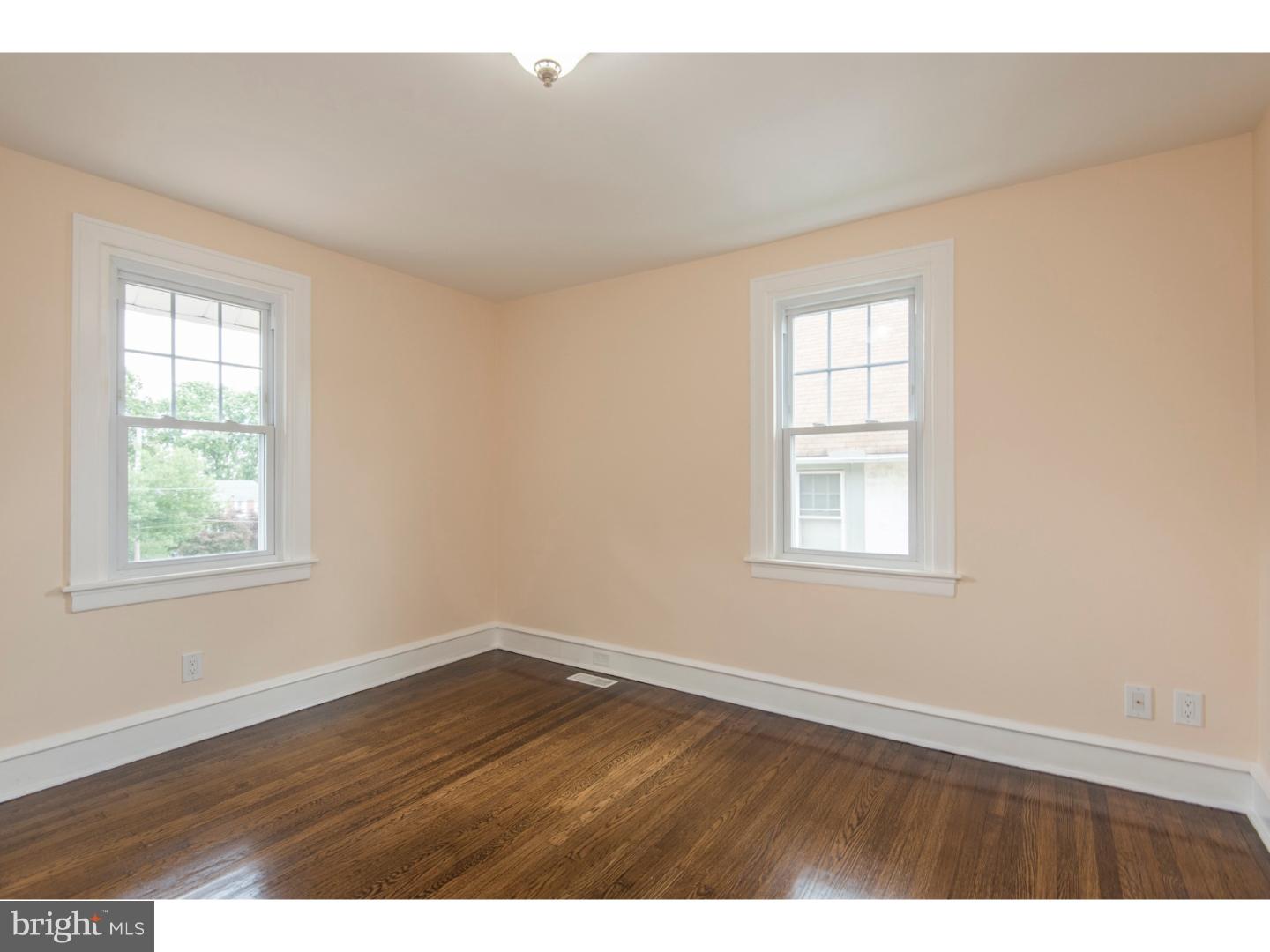 408 Lenox Road Havertown, PA 19083 - Photo 17 of 25 an empty room with wooden floor and windows