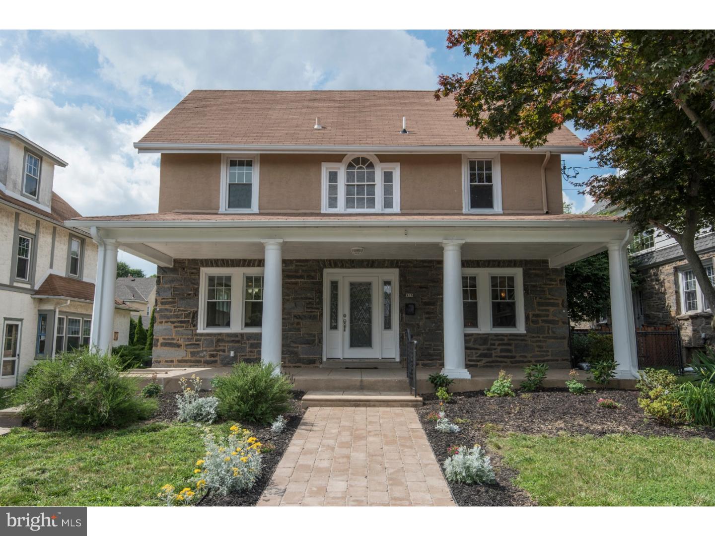 408 Lenox Road Havertown, PA 19083 - Photo 21 of 25 a view of a brick house with many windows plants and large trees