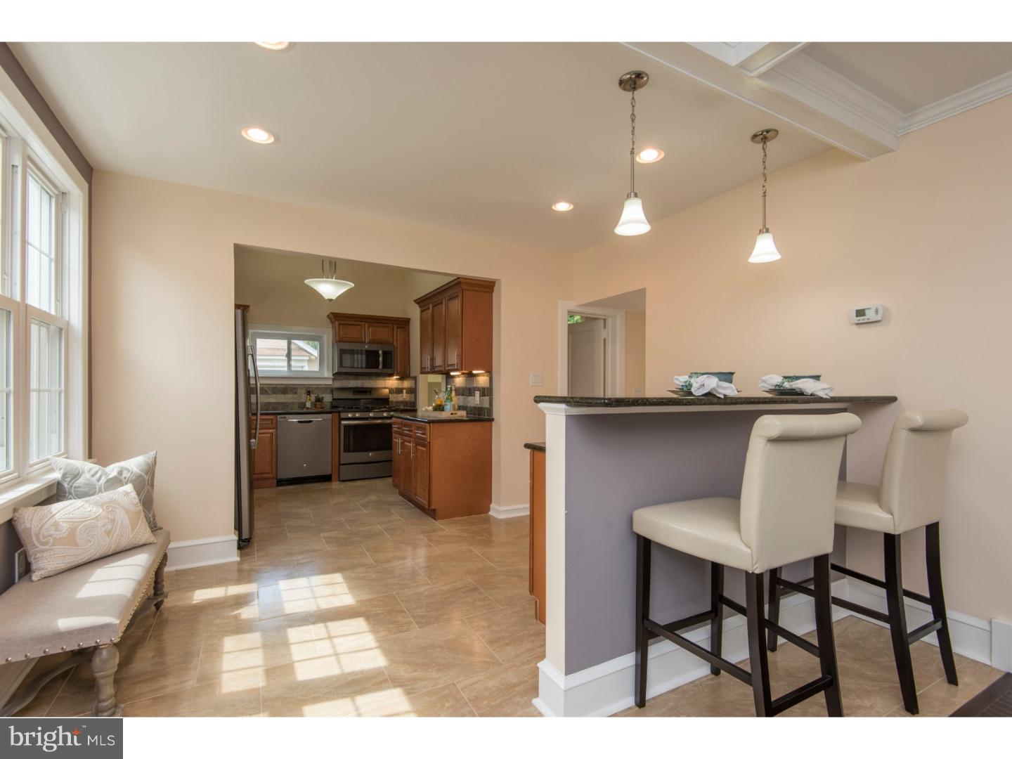 408 Lenox Road Havertown, PA 19083 - Photo 6 of 25 a kitchen with kitchen island a stove a table and chairs in it
