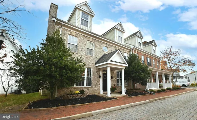 a kitchen with granite countertop a stove a sink and a refrigerator