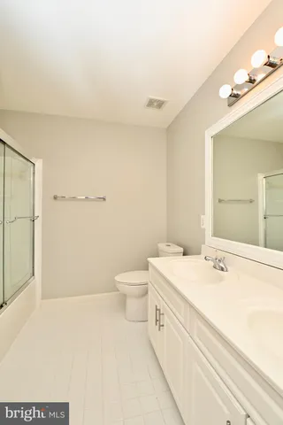 a view of a livingroom with a ceiling fan and window