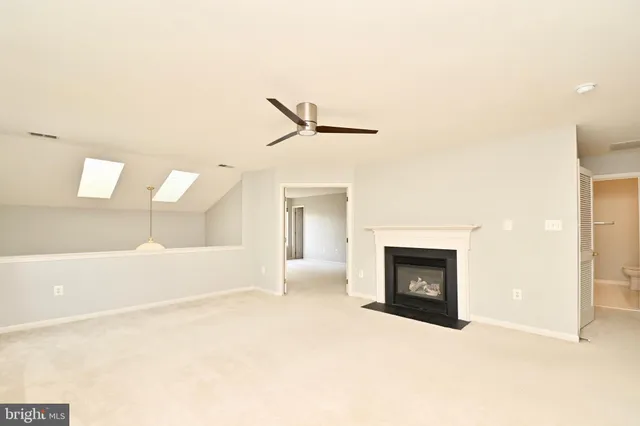 a view of an empty room with a fireplace
