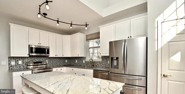 a view of a livingroom with a fireplace and window