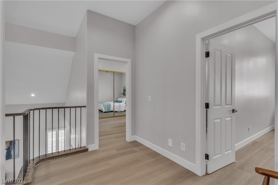 8848 Rainbow Ridge Drive Las Vegas, NV 89117 - Photo 20 of 43 Clean lines and a spacious upper-level landing connect private rooms with architectural grace.
