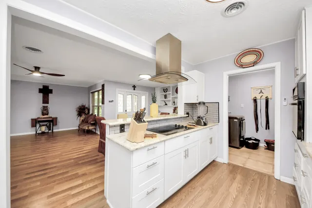 a kitchen with a sink cabinets and window