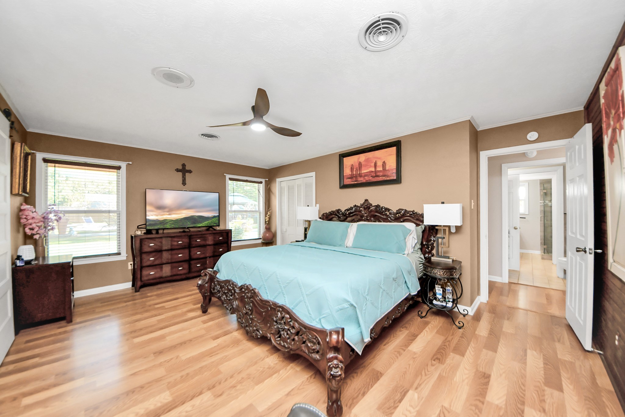 142 Wall Street Cleveland, TX 77327 - Photo 21 of 36 a spacious bedroom with a bed and a flat screen television