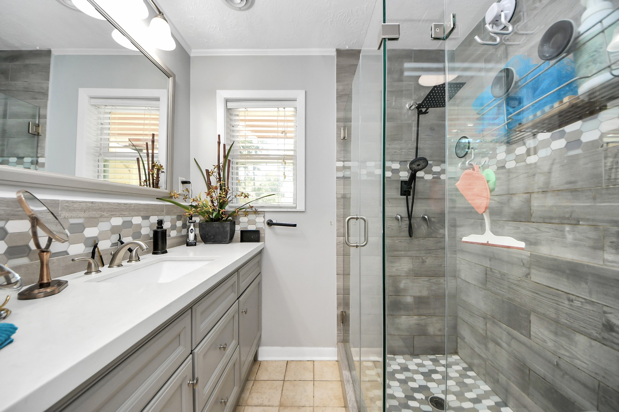 142 Wall Street Cleveland, TX 77327 - Photo 27 of 36 a bathroom with a double vanity sink a mirror and shower