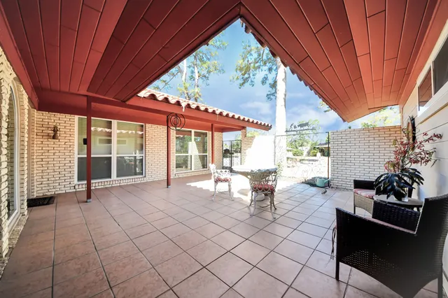 a workspace with wooden floor and furniture