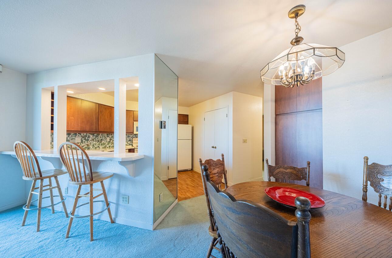 585 Hawthorne Street, Unit 103 Monterey, CA 93940 - Photo 12 of 30 a view of a dining room with furniture window and wooden floor