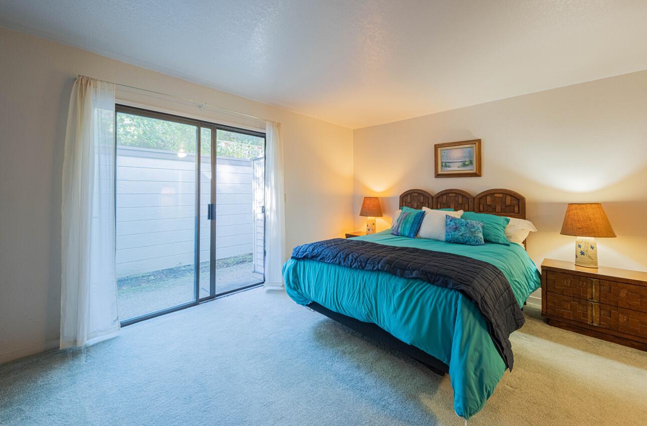 585 Hawthorne Street, Unit 103 Monterey, CA 93940 - Photo 16 of 30 a bedroom with a bed and a night stand